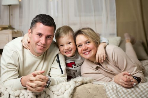 a man and woman with a couple of children on a bed