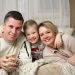 a man and woman with a couple of children on a bed